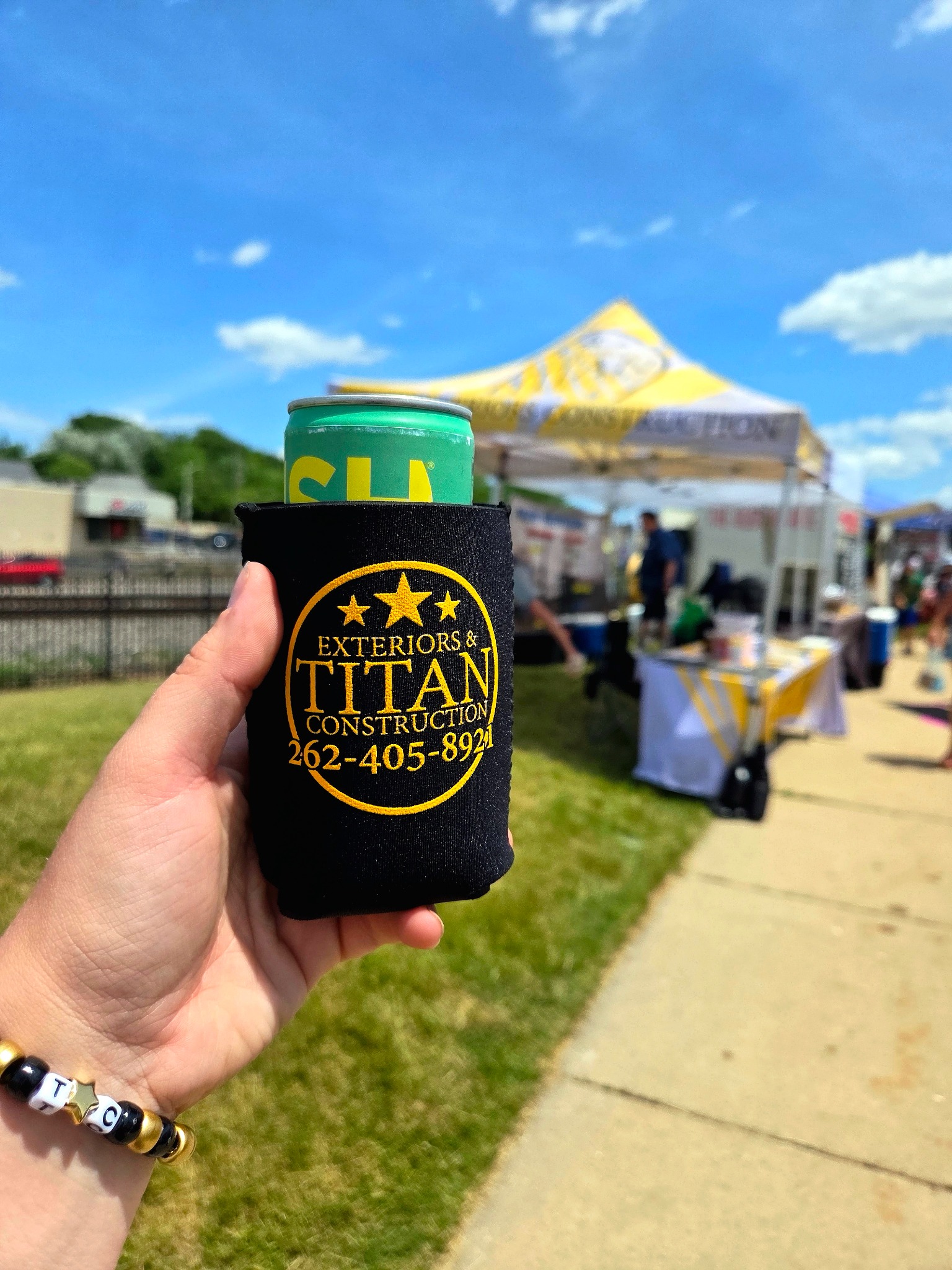 Titan branded can cooler at a sunny community event